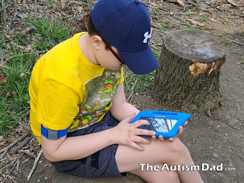 Emmett using the Mightier heart rate sensor while playing on a tablet